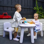 2 boys playing in an outdoor play area on their confetti table and chair set