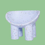 Lilac kids bucket chair on a green background