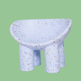 Lilac kids bucket chair on a green background