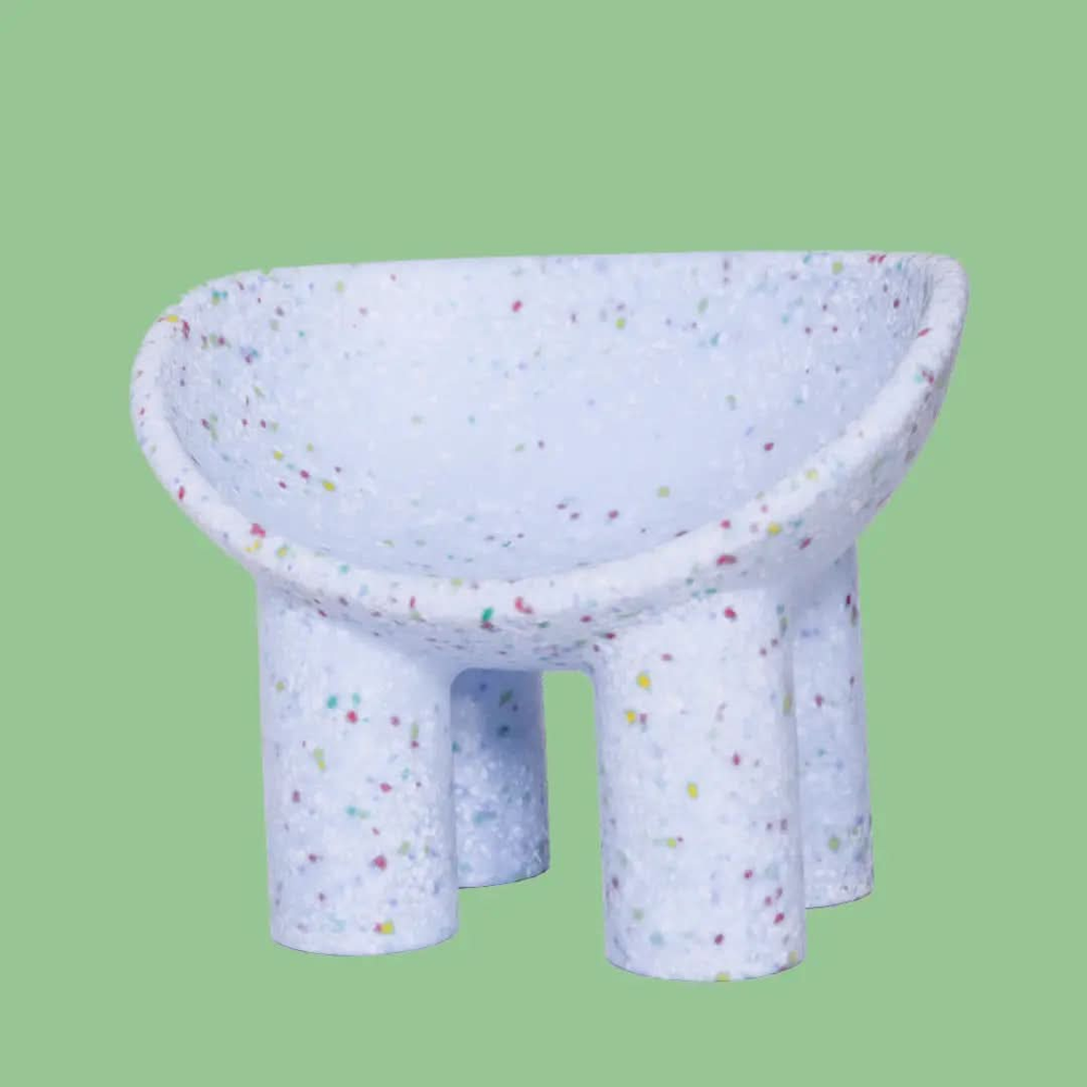 Lilac kids bucket chair on a green background