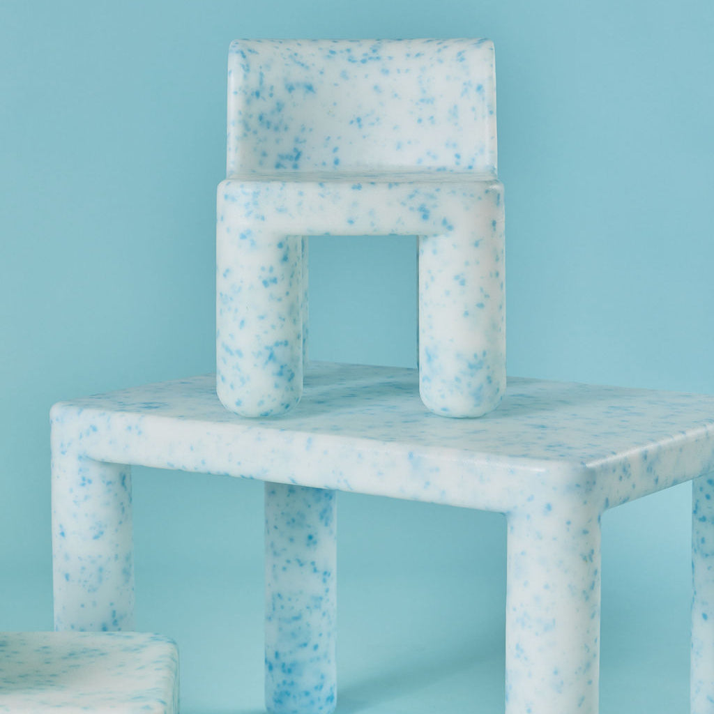 Speckled blue and white chair on a matching blue background