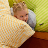 Child playing with Yellow, Blue and orage star shaped bean bag