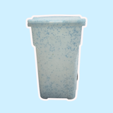 Speckled ceramic planter on a light blue background