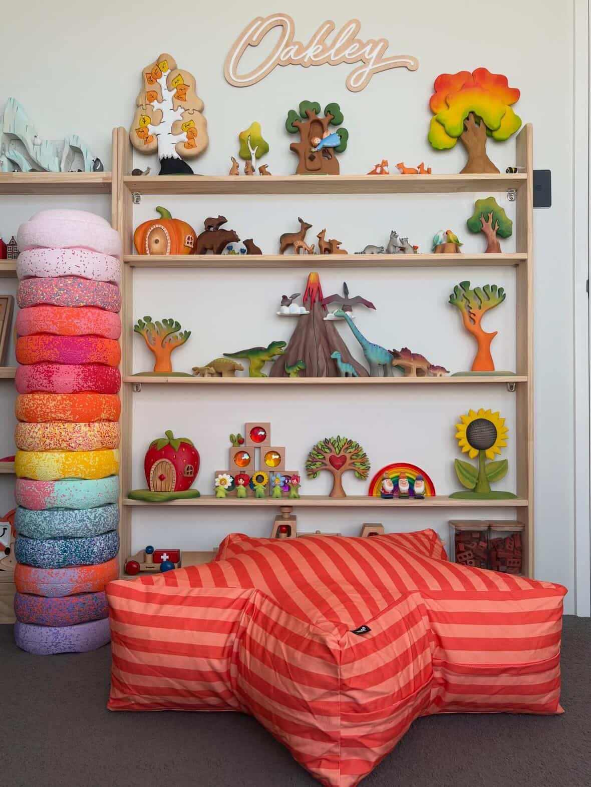 Children's room with colorful toys and a striped bean bag chair.