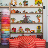 Children's room with colorful toys and a striped bean bag chair.