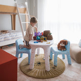 Child playing at a small table with toys in a modern bedroom.