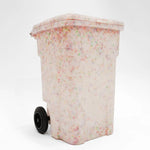 Trash bin with a colorful speckled pattern on a white background