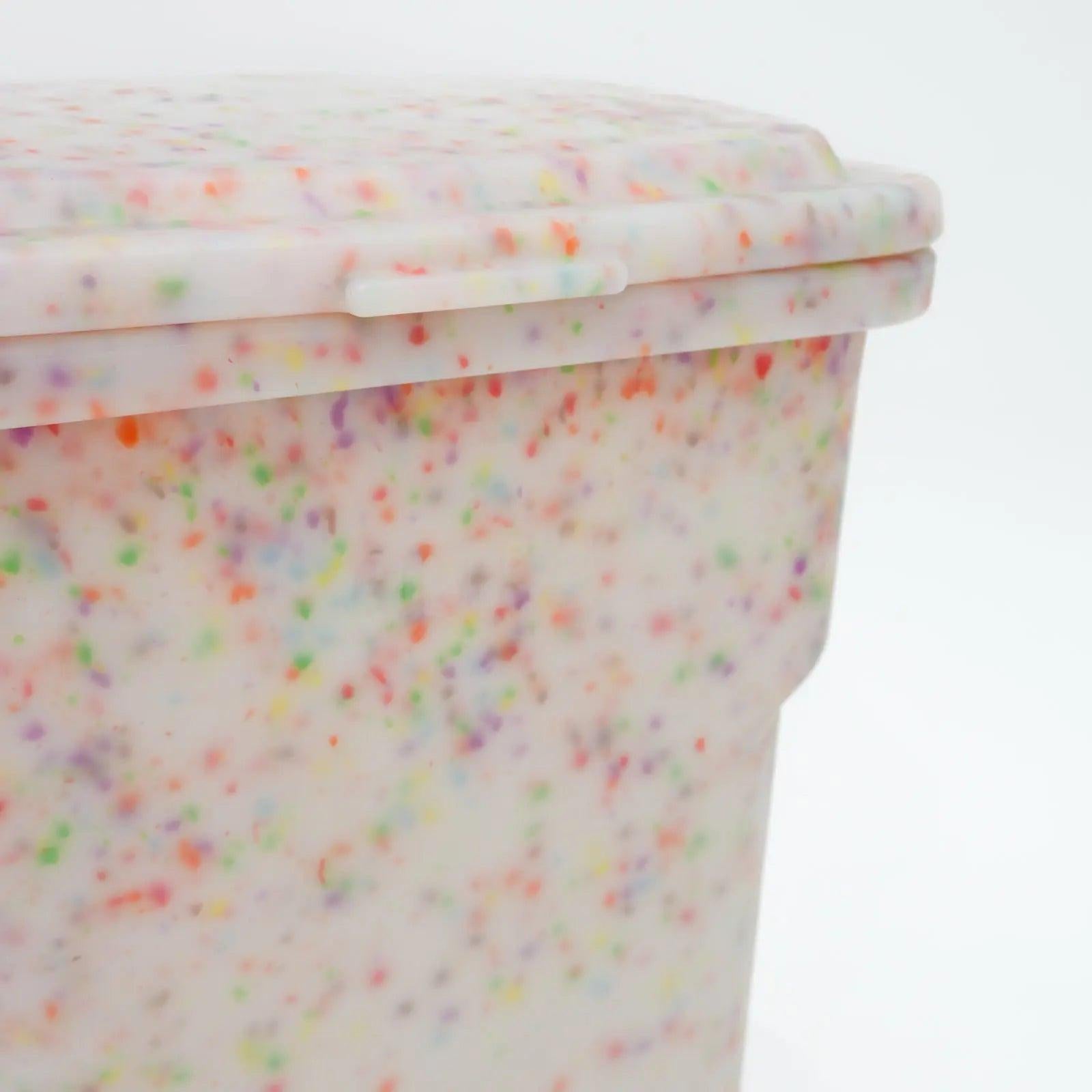 Colorful confetti-patterned container on a white background