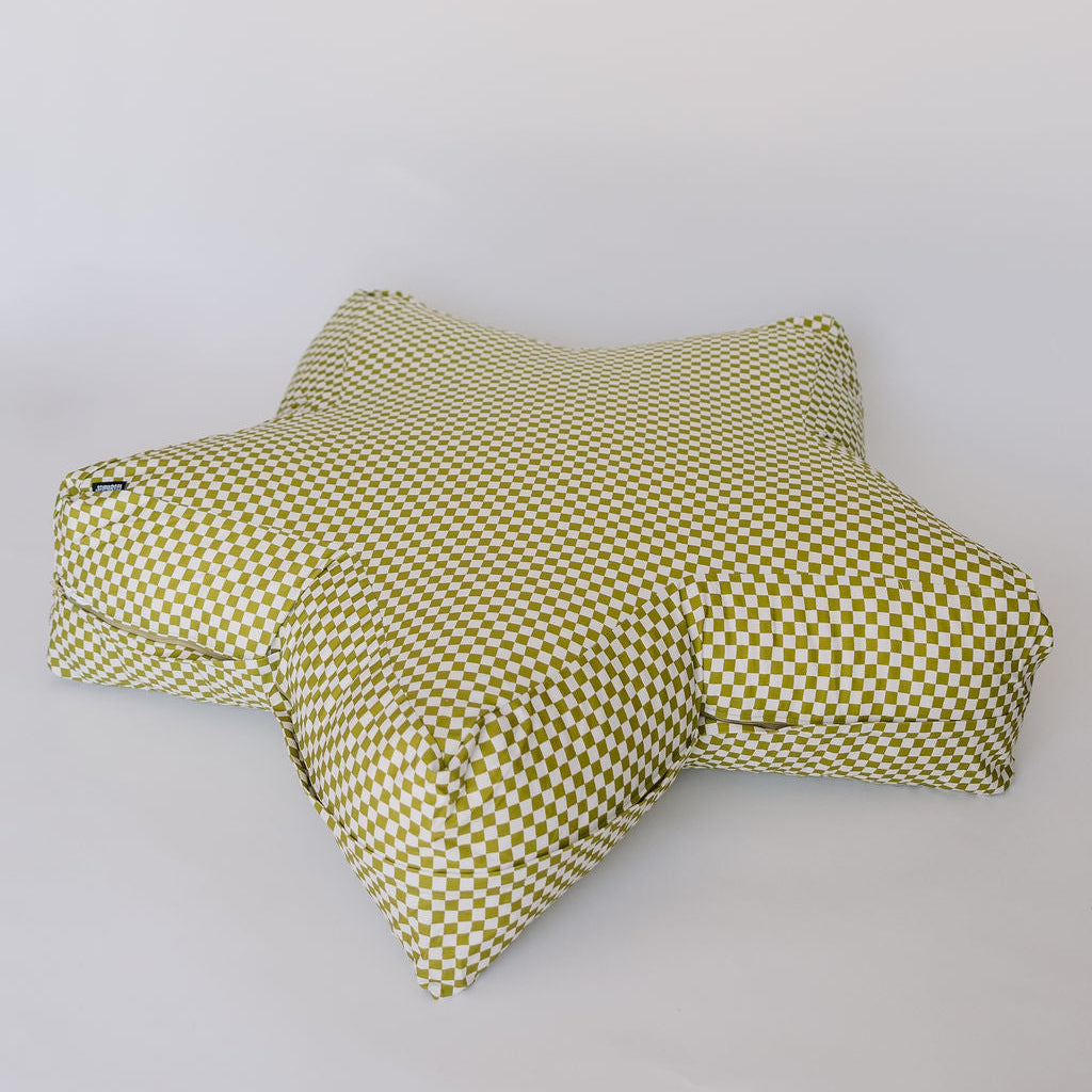 A star-shaped floor cushion with a green and white checkered pattern, photographed on a plain light gray background.