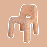 Peach Confetti Chair with a speckled pattern on a beige background