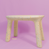 Stool with colorful speckles on a pink background
