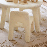 Sand Confetti chairs with a patterned rug underneath