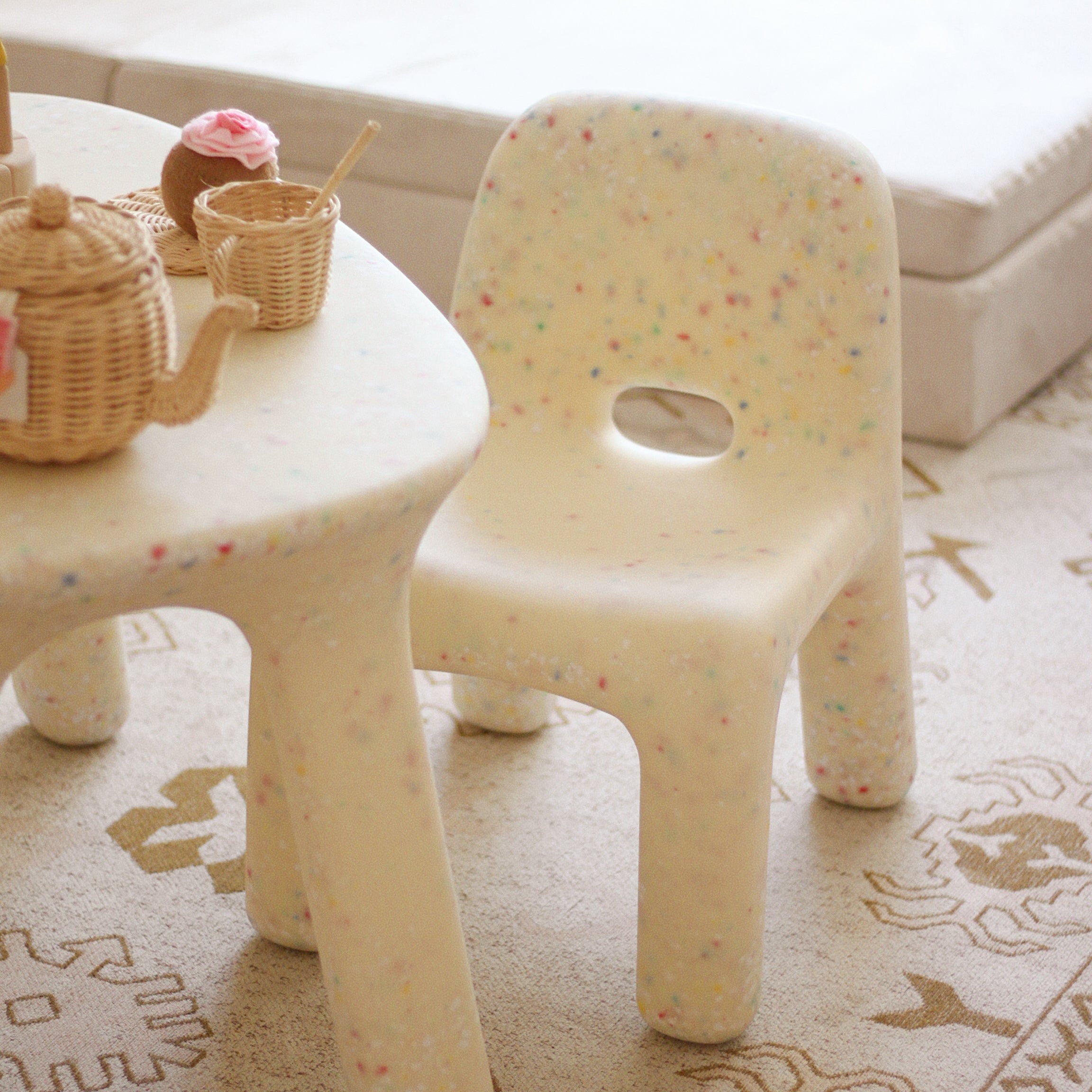 Sand Confertti chair frontward facing in playroom on beige rug