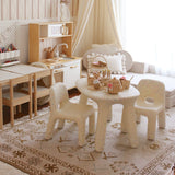 Children's play area with sand confetti  chairs and a rug on floor.