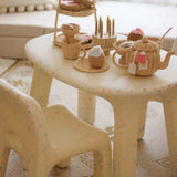 Children's plastic chair with wicker baskets and toys on a patterned rug