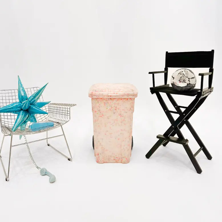 Decorative items including a star-shaped object, a black director's chair with a decorative item, and a pink woven basket on a white background.