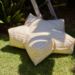 Yellow and white striped bean bag chair on grass